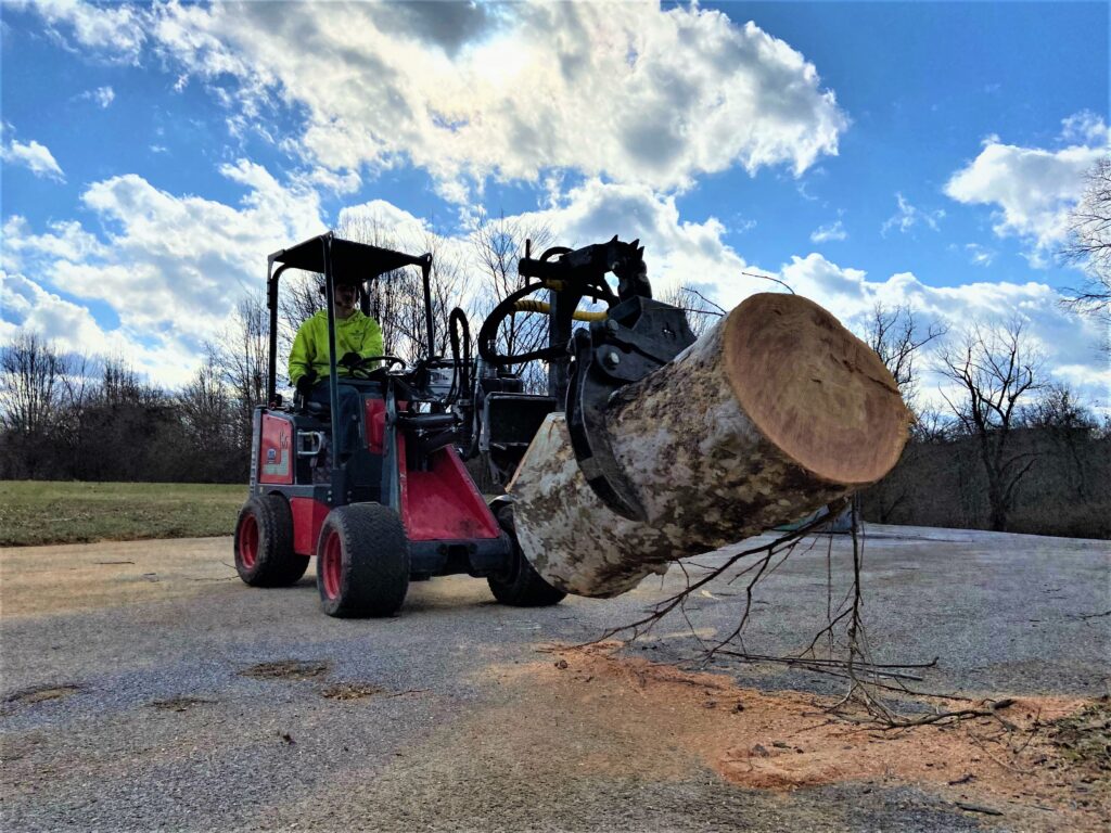 Miniloader for tree care with knock around grapple